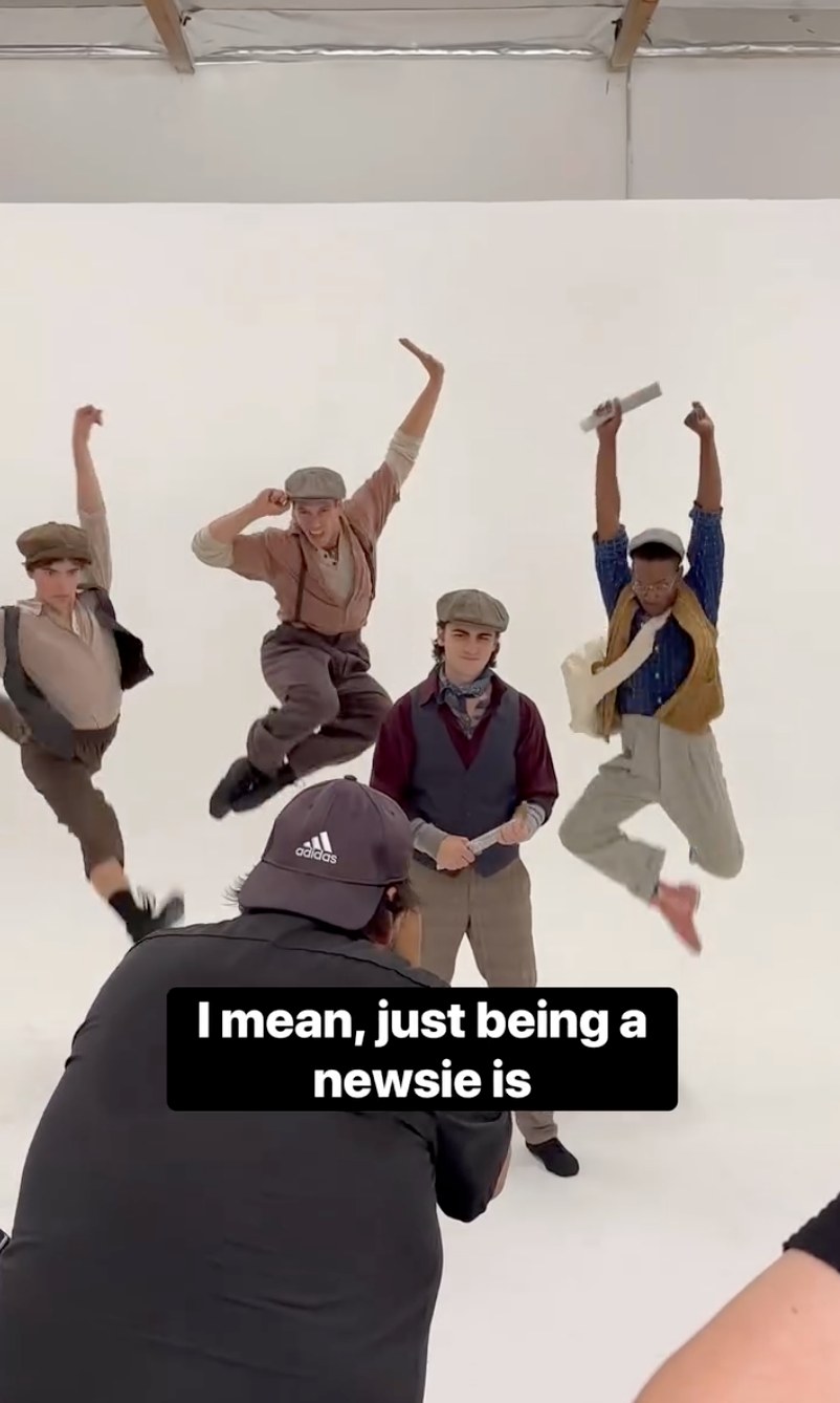 Newsies reel: three newsies mid-jump behind the scenes at the photo shoot